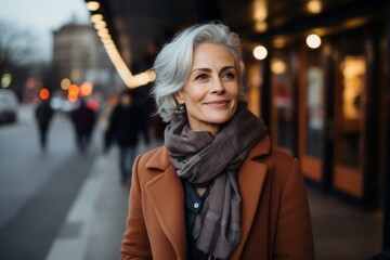 Portrait of a smiling middle-aged woman in the city.