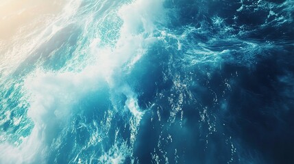 Ocean's Embrace: A breathtaking aerial view of the ocean's surface, capturing the dynamic interplay of sunlit waves and deep blue water. The image evokes a sense of vastness, freedom.
