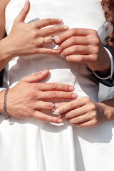 Newlyweds exchange rings, groom puts the ring on the bride's hand.