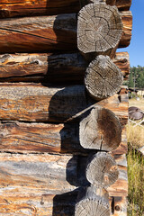 Aged log cabin edge, old ranch building construction, wooden logs