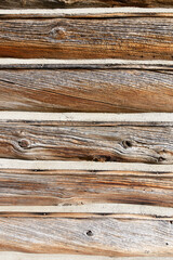 Log cabin siding, old wood building, chinking between logs, aged wooden texture backgound