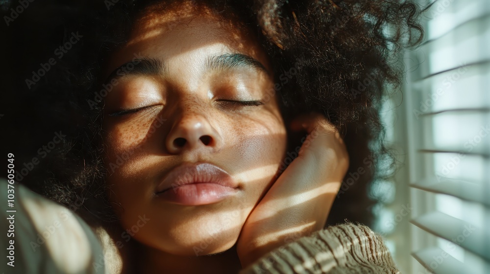 Poster a woman's serene face with closed eyes is gently illuminated by sunlight filtering through blinds, c