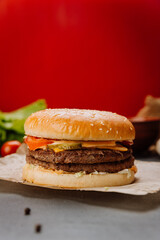 Juicy double cheeseburger with fresh toppings in vibrant setting, ideal for food photography or ads