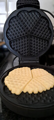 Waffles are baked in a waffle iron