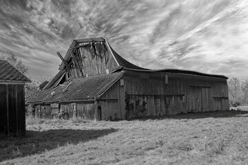 Abandoned and collapsing old barn on a vacant farm in southern Michigan in early Fall