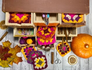 Wooden dot painted drawers with crochet granny square hooks scissors handmade craft autumn vide seasonal photo cosy home 