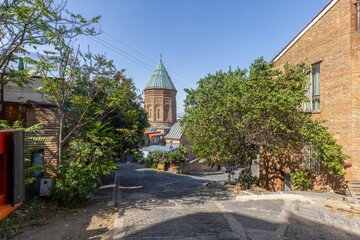 View of the historic Old Town in Tbilisi, Georgia, with shops, trees, and quiet streets