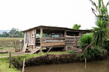 Fototapeta premium Rustic rural building in old wood for raising pigs and chickens