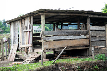 Rustic rural building in old wood for raising pigs and chickens