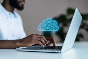 A person is working on a laptop, with a digital cloud icon overlaying the image, representing cloud computing, data management, and modern technology solutions.