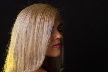 Naklejka premium Caucasian woman with blond hair in a red dress posing for a photo in a studio in the city of Salvador, Bahia.