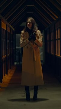 A Mysterious Figure Stands in a Dimly Lit Corridor During the Late Evening Hours