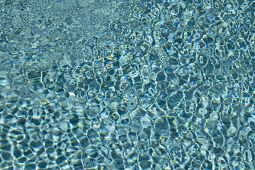 Water view. Pool water background. Blue water texture background. Sea water and ripples. Textured background.