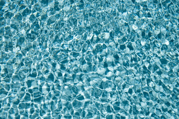 Water view. Transparent water background. Blue pool water texture background. Surface of pool water with ripples.