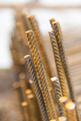 A shallow depth of focus shot of a collection of rusty iron bars near a construction site in Gent.