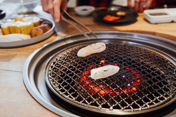 Grilled Squid on a Yakiniku or Korean BBQ Grill In Table Restaurant