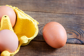 Closeup macro of pasture raised farm fresh dozen brown eggs store bought from farmer in carton box...
