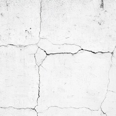 Obraz premium Close-up of a cracked white concrete wall, showcasing intricate textures and patterns.
