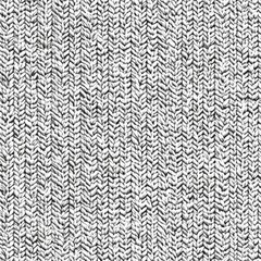 Close-up of textured gray knit fabric, showcasing intricate patterns and fine details.