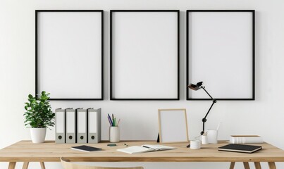 白い壁に3つの白い額縁が飾られたミニマルなホームオフィス。木製の机の上には事務用品が置かれている