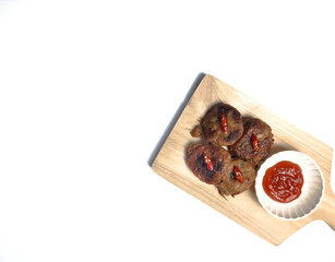 Perkedel, made of mashed potatoes and minced meat with sauce or chili paste (sambal). Indonesian fried patties