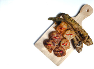 Perkedel, lele goreng or fried catfish, and fried tofu with sauce or chili paste (sambal). Indonesian fried patties