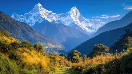 Obraz premium Majestic mountain range with snow capped peaks under a clear blue sky creating a breathtaking landscape ideal for nature enthusiasts