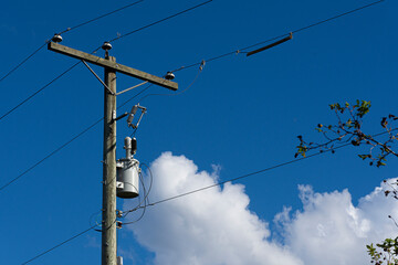 An image of a power pole with power transformer for rural power distribution.