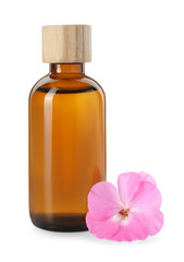 Geranium essential oil in bottle and beautiful flower isolated on white