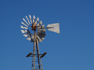 old windmill against sky background