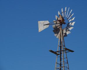 old windmill against sky background