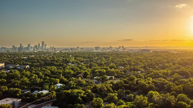 4K+ Aerial time-lapse over Mueller of Austin, Texas with a view of the downtown skyscrapers at sunset