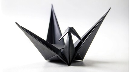 Macro black origami paper crane on white background