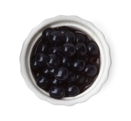 Dark tapioca pearls in bowl isolated on white, top view