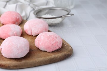Tasty homemade mochi on white tiled table, closeup
