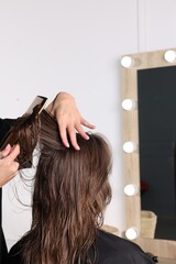 Fototapeta premium Hair cutting. Professional hairdresser working with client in salon, closeup