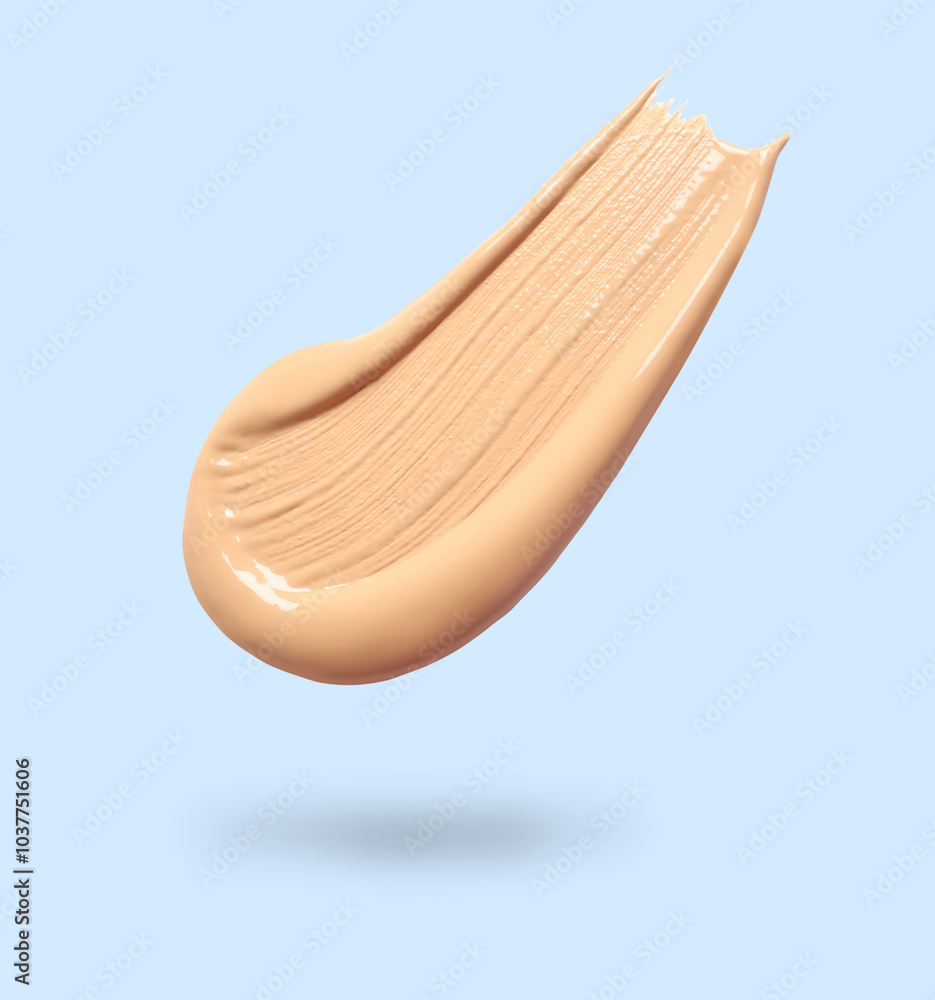 Poster Skin foundation in air on light blue background. Cosmetic product