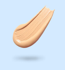 Skin foundation in air on light blue background. Cosmetic product