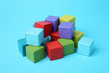 Obraz premium Many colorful cubes on light blue background