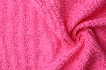 Clean pink microfiber cloth as background, top view