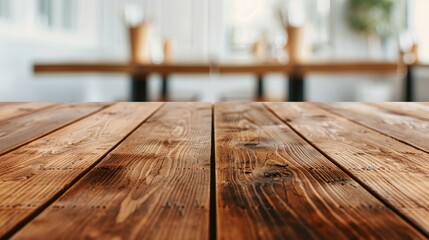 A cozy cafe scene with a blurred backdrop, showcasing a sleek wooden table inviting you to relax and unwind.