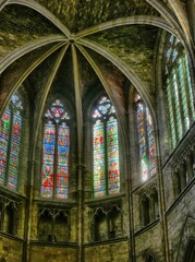 Sunlight streaming through stained glass windows illuminating cathedral interior