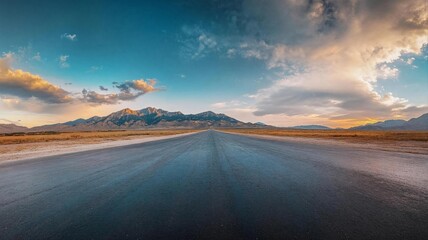 Fototapeta premium Majestic Mountain Road: Scenic Desert Highway Under Dramatic Sky
