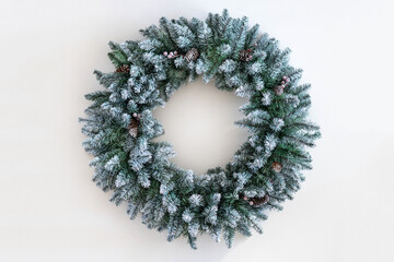 Christmas wreath made of live fir branches and toys on a white background, template for design,