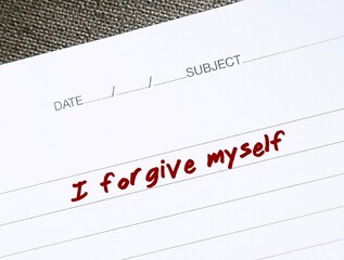 Notebook with message text I FORGIVE MYSELF, positive affirmation of learning to fully accept...