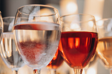 A row of wine glasses filled with different types of wine
