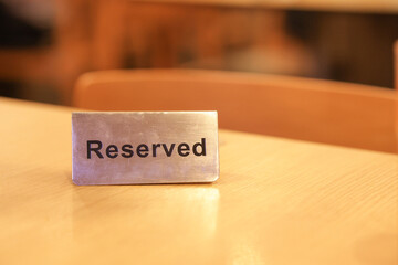 A table reservation sign is placed on the table. Reserved dining tables will be labeled.