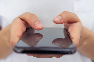 Hand holding smartphone mockup of blank screen, Take your screen to put on advertising.