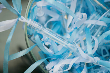 A jar that is filled with finely shredded pieces of paper along with a toothbrush resting inside it. It creates an interesting visual