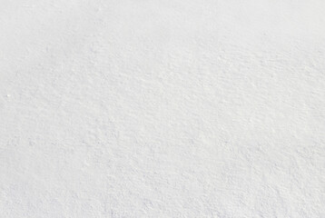 Closeup of fresh, untouched snow surface with natural soft textures, ideal for backgrounds or winter-themed designs.